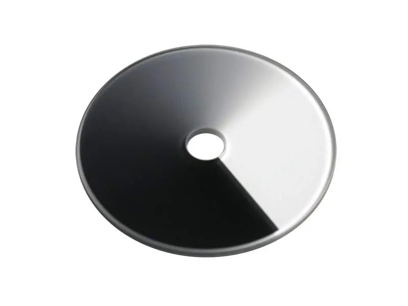 Round, black and white, metal disc.