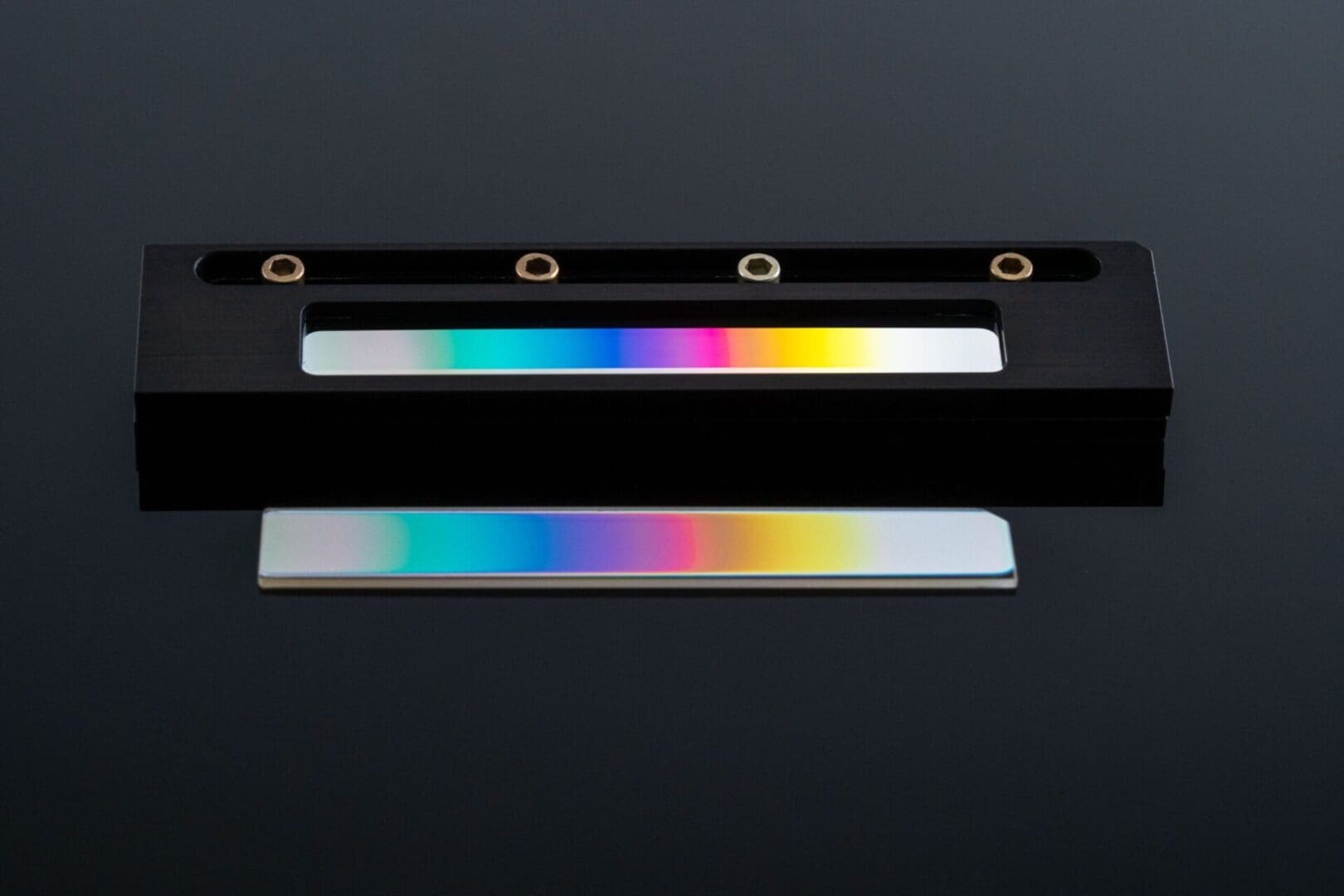 Rainbow diffraction grating in holder.